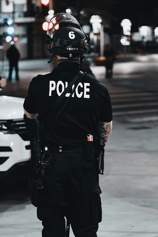 back of a man in police uniform