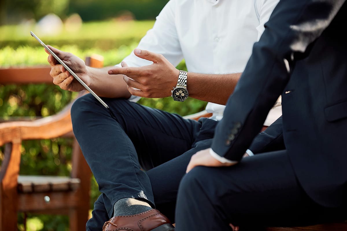 person providing mentoring and coaching on tablet in a park